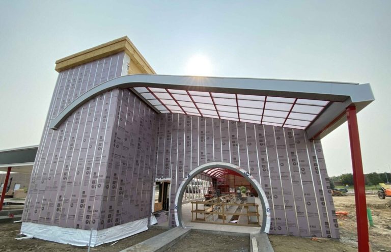 External cladding and custom awning on car wash exterior.