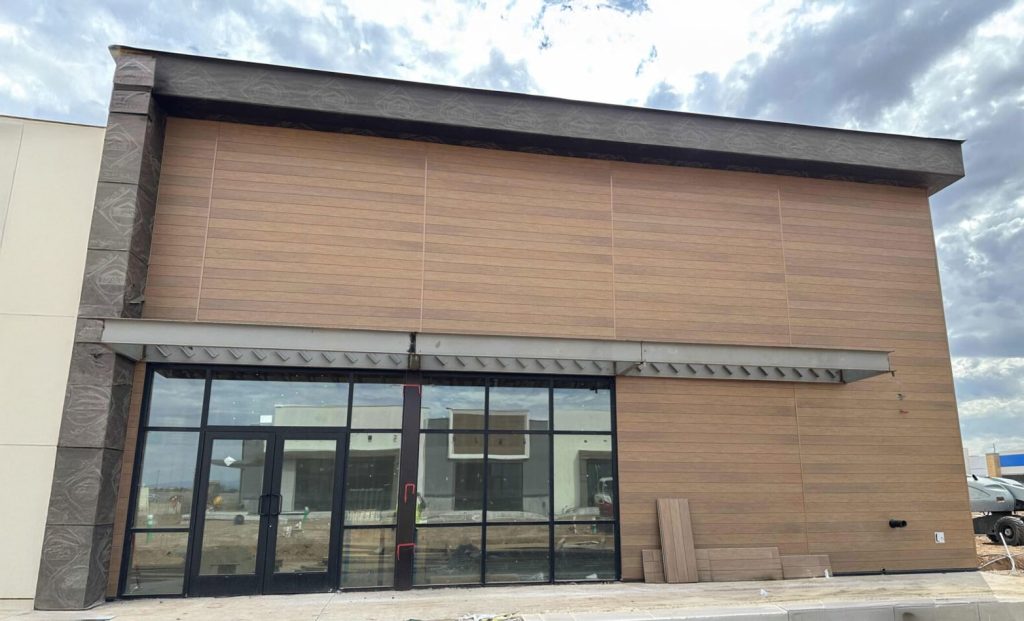 Woodgrain cladding installed on exterior of building.