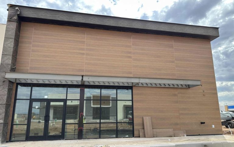 Woodgrain cladding installed on exterior of building.