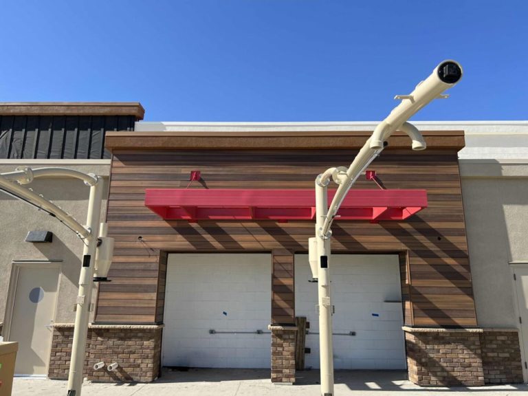 Woodgrain external cladding with red awning.