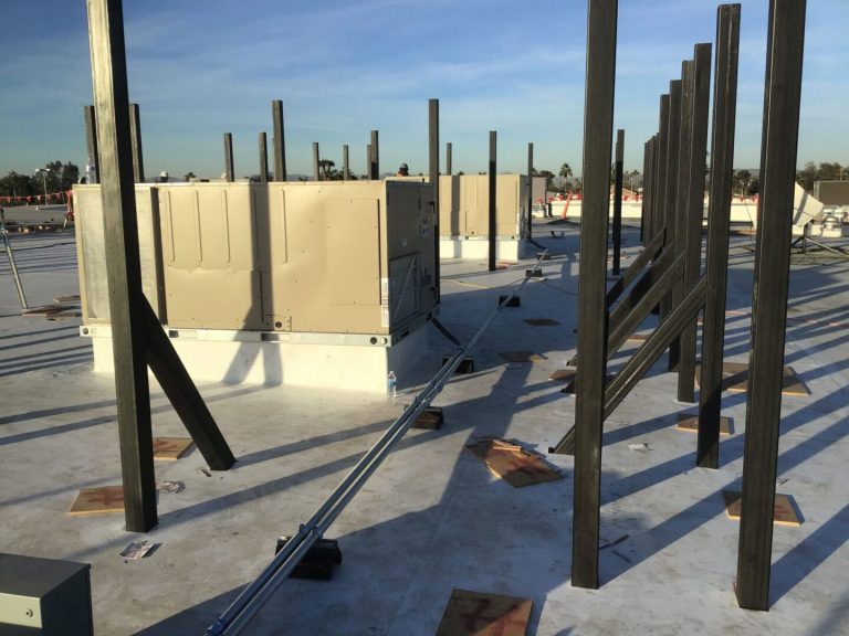 Metal stud structure framing in large AC units on a roof.