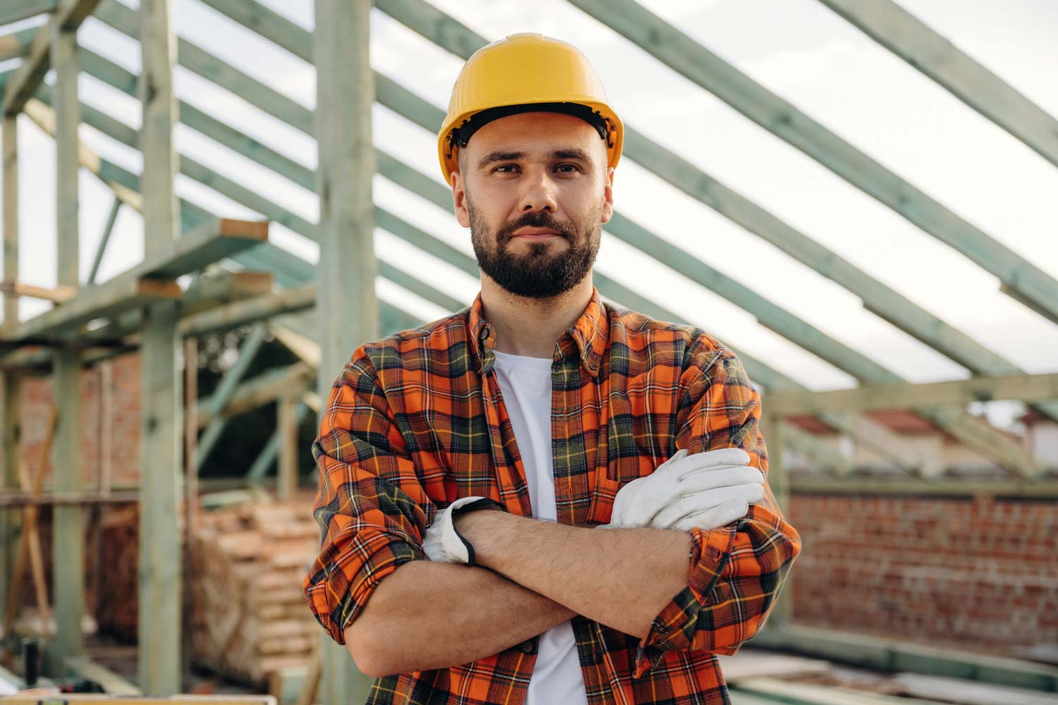 A construction worker standing on a roof