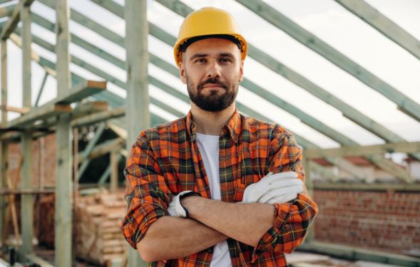 A construction worker standing on a roof