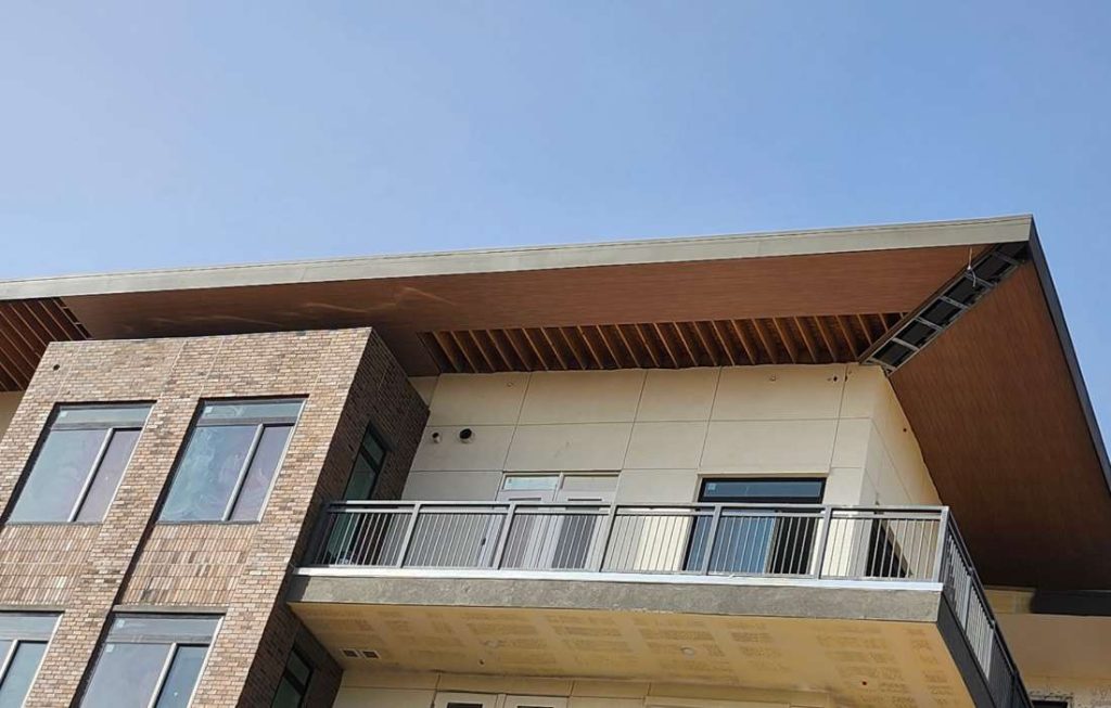 Multi-level building with different colors of exterior cladding.